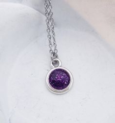 "Cremation Necklace - Pet Loss Gift - Ashes Jewelry - Memorial Jewelry - Pet Cremation Jewelry - Memorial Keepsake - Glitter Ashes - Dainty This beautiful, dainty necklace is made using your beloved pet's actual ashes. You may be able to see the ashes, but I will add a touch of glitter to highlight the piece. The disc pendant is approximately 1/2\" and graces a dainty stainless steel link chain. Please contact us after you've ordered for instructions on how/where to ship the ashes for your neckl Sparkling Purple Jewelry For Gift, Sparkling Purple Jewelry Gift, Glitter Round Jewelry As Gift, Round Glitter Jewelry As Gift, Round Glitter Jewelry For Gifts, Silver Glitter Necklace For Gift, Purple Glitter Jewelry Gift, Purple Glitter Jewelry For Gifts, Pet Cremation Jewelry