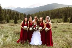 a group of women standing next to each other in a field