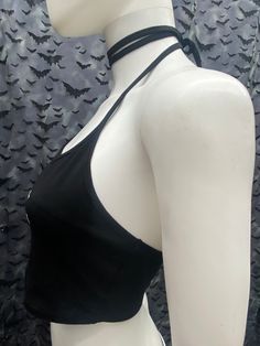 This is a black Void cropped halter top with tie back strings on the neck. They're very long so you can wrap them around the neck for a collared look or just tie back. Scroll thru the photos for different ways of wearing. This has a Void logo image screen printed on the front. 95% Cotton/ 5% Spandex These are handmade screen-printed and may slightly vary from the photo. Please feel free to email me any questions. Thanks for looking. Due to an influx of incorrect addresses if a package is returne Black Halter Neck Crop Top Y2k Style, Gothic Crop Top For Festivals, Night Out Halter Neck Top With Crisscross Straps, Edgy Stretch Crop Top For Alternative Fashion, Black Halter Neck Top For Spring, Halter Neck Top With Crisscross Straps For Night Out, Spring Gothic Stretch Crop Top, Y2k Halter Neck Top For Club, Fitted Strappy Halter Top For Festivals