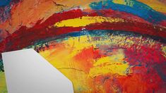 an abstract painting with bright colors on the wall