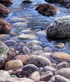 some rocks and water are on the shore