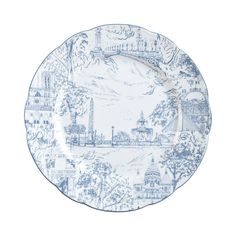 a blue and white plate with an image of a city on it