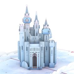 a castle made out of paper sitting in the snow