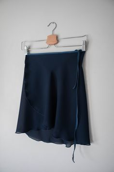 "Our classic, navy -colored wrap ballet skirt is exactly made for that! This ballet dress is handmade with a stretchy blue nylon waist tie for a comfortable experience. Crafted 100% out of polyester chiffon with a right above the knee design for a vintage look. ✷ Perfect for Recital ✷ This navy blue ballet dress is the perfect choice for a vintage/classy-style recital. A conservative style with a right above the knee design for a formal performance. Not only that, this skirt can also be used on Blue Ballet Dress, Conservative Style, Short Wrap Skirt, Long Wrap Skirt, Fabric Steamer, Conservative Fashion, Ballet Dress, Classy Style, Figure Skater