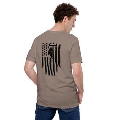 a man standing with his back to the camera wearing a t - shirt with an american flag on it