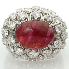 For Sale on 1stdibs - This captivating ring from David Webb features an open-design dome crown prong-set with an oval 11.0mm x 15.0mm cabochon ruby and surrounded by 36 sparkling Round Cut Engagement Ring, Cabochon Ruby, Titanic Jewelry, David Webb, Ruby Diamond Rings, Dome Ring, Round Cut Engagement Rings, Anniversary Gifts For Wife, Ruby Jewelry