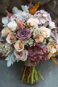 a bridal bouquet with purple and white flowers