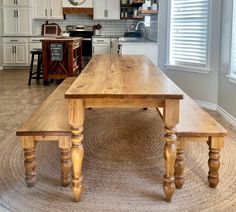 a wooden table sitting in the middle of a kitchen