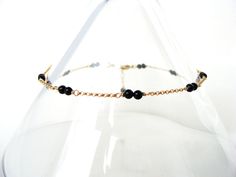 Dainty black tourmaline anklet, goldfill, 9-10 inches, elegant feminine summer style, gold ankle bracelet, handmade Let Loose Jewelry Elegant and dainty anklet for warm fashion accessorizing~ a fine, goldfilled rolo chain is dotted with stations of doubled black tourmaline beads. The length adjusts to give you some wiggle room- 9-10 inches. The simple style will compliment casual daywear to a LBD. Finished with a petite lobster clasp, all metal is gold-fill. Stones: tourmaline Colors: black, gol Elegant Adjustable 14k Gold-filled Anklets, Elegant Adjustable 14k Gold Filled Anklets, Dainty Anklet, Feminine Summer, Jewelry Elegant, Elegant Feminine, Tourmaline Beads, Ankle Bracelet, Rolo Chain