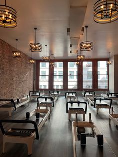 an empty restaurant with wooden benches and brick walls