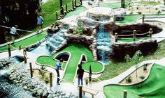 people are playing miniature golf in the park