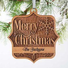 a wooden ornament hanging from a christmas tree with snowflakes on it