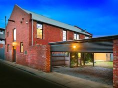 a red brick building with an attached garage