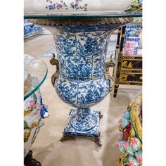 a blue and white vase sitting on top of a glass table