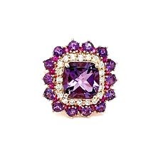 an amethorate and diamond ring with purple stones in the center, on a white background