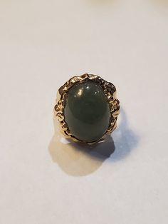 You are viewing a beautiful 14k mings green translucent jade cabochon ring. The total weight of the ring is approx.8.6 grams. The ring size approx.5 3/4 can size up or down. The ring itself measures approx.21mm x 19mm wide. Beautiful green jade translucent cabochon. Send me a message if you have any question. MAKE AN OFFER Yellow Gold Jade Cabochon Ring, Oval Jade Rings In Yellow Gold, Yellow Gold Jade Jewelry With Cabochon, Green Oval Cabochon 14k Stamped Jewelry, 14k Gold Green Gemstone Dome Ring, Heirloom Green Jade Rings, Formal Yellow Gold Jade Ring, Formal Green 14k Gold Dome Ring, Green Emerald Oval Cabochon Ring Stamped 14k