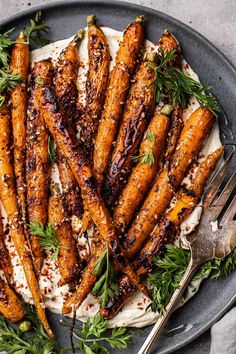 grilled carrots on a plate with herbs