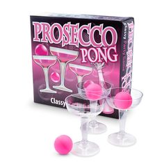 three wine glasses with pink balls in front of a boxed box for the game prosteco pong