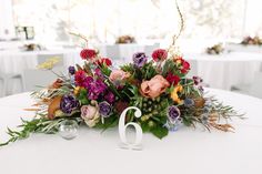 a table with flowers and candles on it