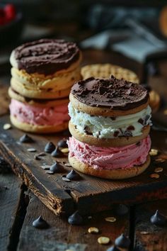 three cookies and ice cream sandwiches on a wooden board