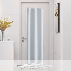 a white door with a silver curtain in front of it and a vase on the side