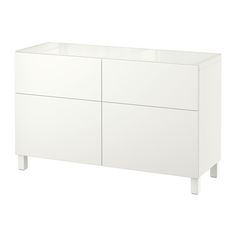 a white cabinet with three drawers and two doors