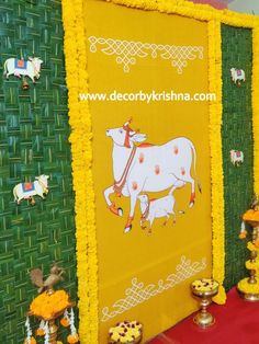 a decorated wall with cows and flowers on it