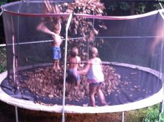 two young children playing in a trampoline