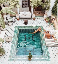 an aerial view of a pool with people in it