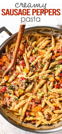 creamy sausage pepper pasta in a skillet with a wooden spoon and text overlay