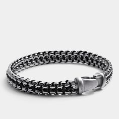 The Argos Steel Link Bracelet is a striking fusion of modern design and timeless craftsmanship. This bracelet boasts intricately woven links, crafted from high-grade stainless steel, exuding a powerful yet refined aesthetic. Whether paired with a suit or casual attire, the Argos elevates your look with its distinctive, polished finish. Make a statement of quiet confidence and timeless elegance with the Argos Steel Link Bracelet. Modern Silver Braided Bracelet, Modern Silver Braided Bracelets, Modern Gunmetal Jewelry With Stainless Steel Clasp, Modern Adjustable Gunmetal Chain Bracelet, Modern Gunmetal Chain Bracelet, Classic Silver Metal Braided Bracelet, Modern Adjustable Sterling Silver Bracelet With Box Chain, Modern Metal Braided Jubilee Bracelets, Luxury Link Chain Bracelet With Stainless Steel Clasp