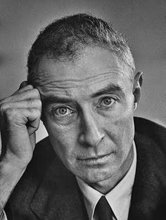 an old black and white photo of a man in a suit looking at the camera