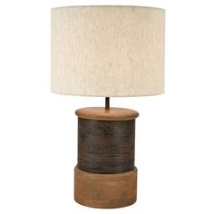 a table lamp with a wooden base and fabric shade on the top, against a white background