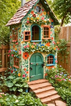 a little house with flowers painted on it