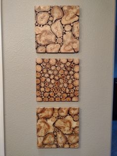 three pieces of wood are hanging on the wall