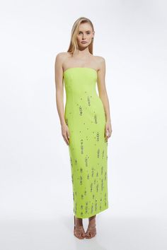 a woman in a lime green strapless dress with sequins on the side