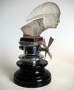 a glass sculpture of a man's head on top of a coffee grinder