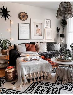 a living room filled with lots of furniture and pictures on the wall above it's coffee table