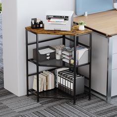 an office desk with a printer, file cabinet and bookshelf in the corner