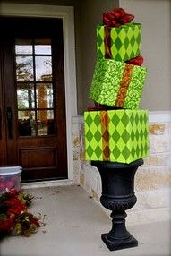 three wrapped presents are stacked on top of each other in front of a door way