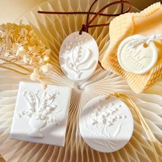 three soaps sitting on top of a paper fan