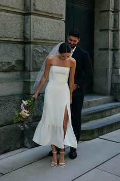 the bride and groom are standing outside together