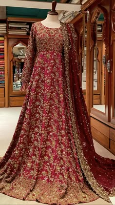 a red and gold wedding gown on display