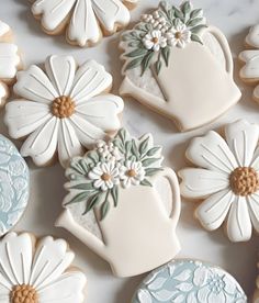 cookies decorated with flowers and watering can on a table