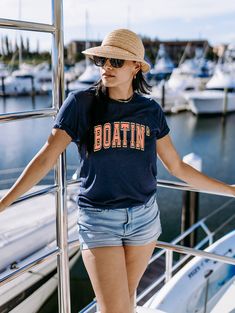 Summer and lake ready Blue Cotton Tops For Boating, Summer Cotton Tops For Boating, Summer Short Sleeve Tops For Boating, Casual Navy Crew Top, Graphic Print Short Sleeve Tops For Boating, Crew Neck Top With Letter Print For Boating, Sporty Navy T-shirt For Summer, Casual Navy Summer T-shirt, Navy Relaxed Fit T-shirt For Summer