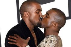 two black men kissing each other in front of a wall with a triangle on it