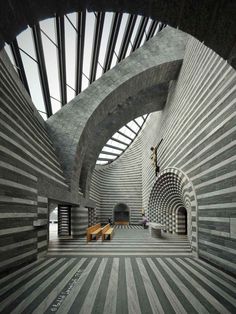 the inside of a building with an arched ceiling and striped flooring on both sides