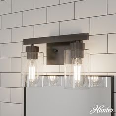 a bathroom vanity light with three lights on the side and a mirror in front of it