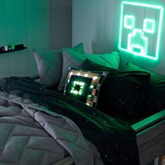 a bed that has some pillows on it and a neon sign in the back ground