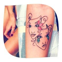 a woman's arm with two faces on it and one has a flower in her hair